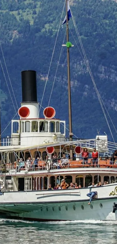 Vintage ship cruising on a scenic mountain lake.