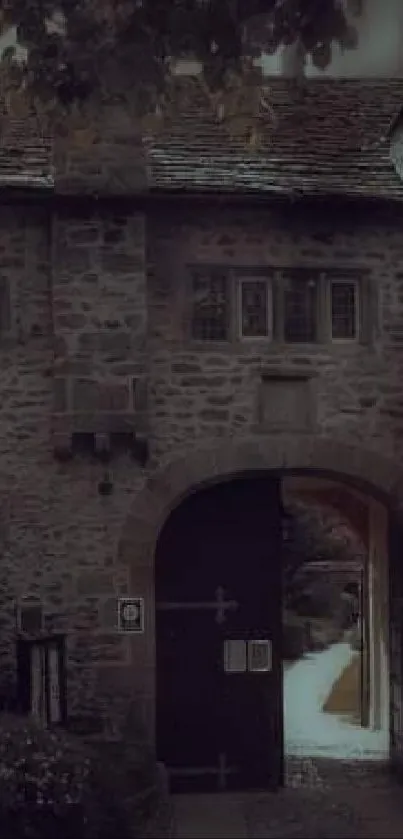 Vintage stone castle entrance with an arched doorway and surrounding greenery.