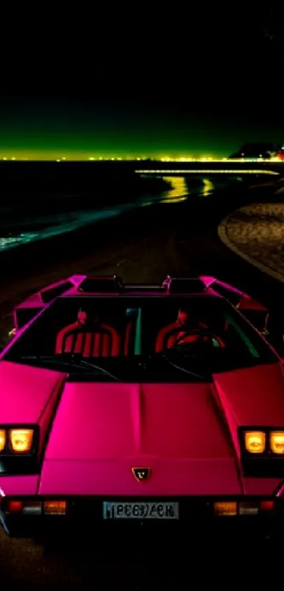 Pink vintage supercar on night beach road.