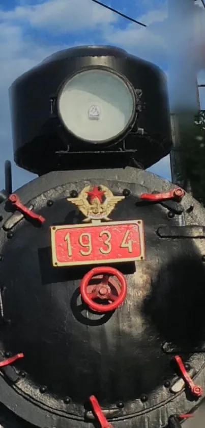 Vintage steam train engine from 1934 with red details.