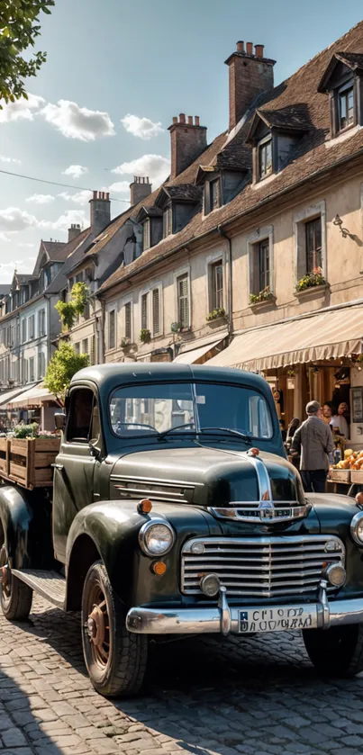 Vintage truck parked on quaint cobblestone street with charming village setting.