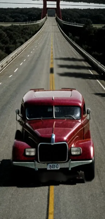 Red vintage truck driving on a scenic highway.