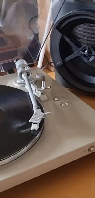 Vintage turntable with vinyl record and speaker setup.