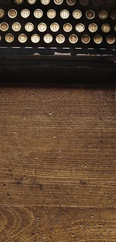 Vintage typewriter on rustic wooden desk wallpaper.