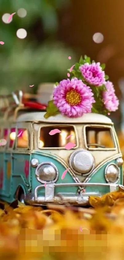 Vintage van with pink flowers on fall leaves background.