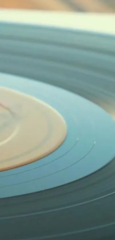 Vintage vinyl record with a teal hue spinning on a turntable, perfect for a retro look.