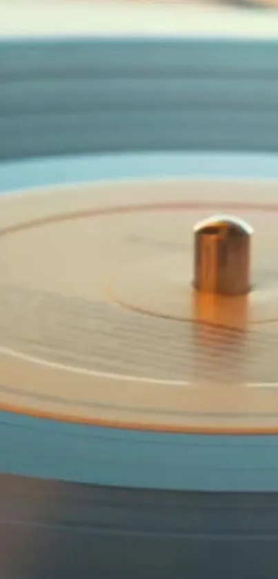 Close-up view of a spinning vinyl record with blue and orange hues.