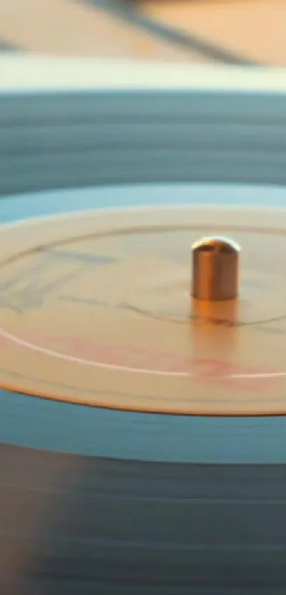 Close-up of a spinning vinyl record on a turntable, featuring warm orange tones.