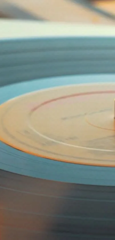 Close-up of a vintage vinyl record with warm orange tones.