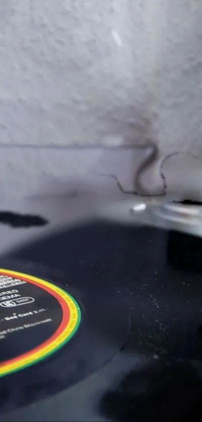 Close-up of a vintage vinyl record player on a textured gray background.