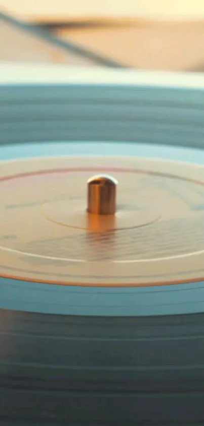 A spinning vintage vinyl record with warm beige tones.