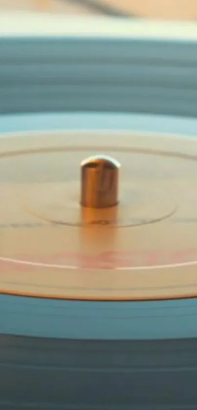 Close-up of a spinning vintage vinyl record with warm beige tones.