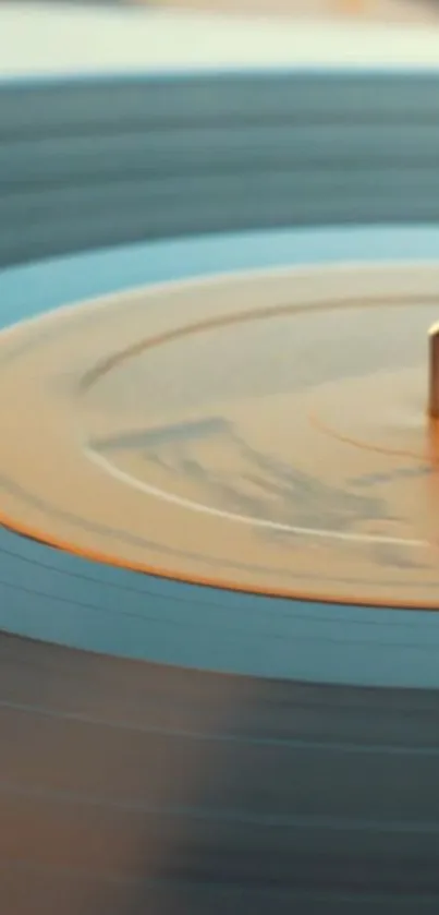 Close-up of a vintage vinyl turntable with warm orange hues.