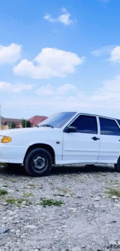 A vintage white car under a blue sky.