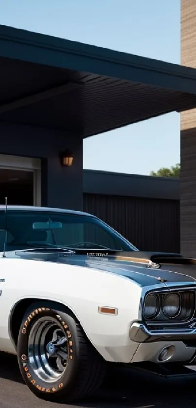 Vintage white muscle car parked by modern building.