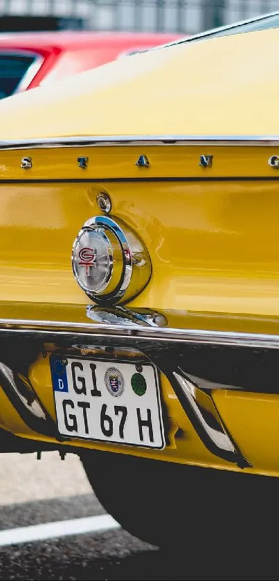 Yellow vintage Mustang car parked rear close-up.