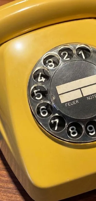 Vintage rotary phone in yellow showcasing classic design.