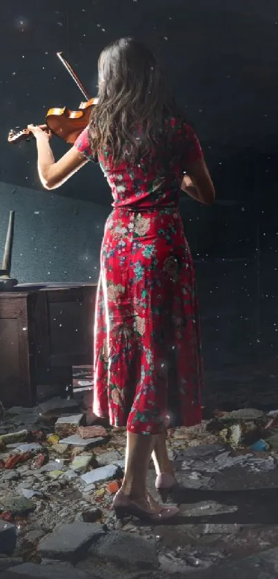 Violinist playing in a dark room in a red floral dress.