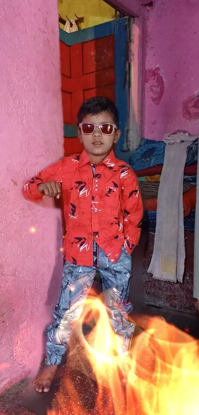 Child in vibrant outfit with fiery background.