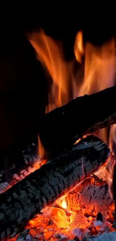 Mobile wallpaper featuring vivid flames and glowing embers on burning logs.