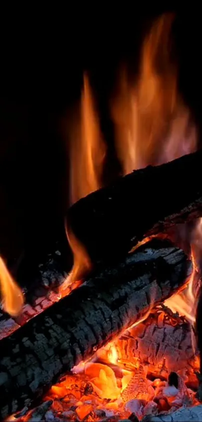 Mobile wallpaper of vivid orange flames and burning logs.