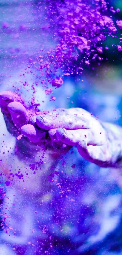 Hands in purple dust creating a vibrant splash effect.