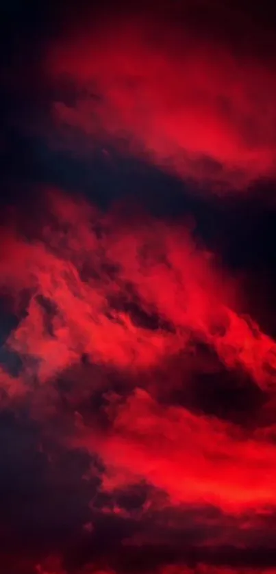 Dramatic red clouds against a dark sky wallpaper.