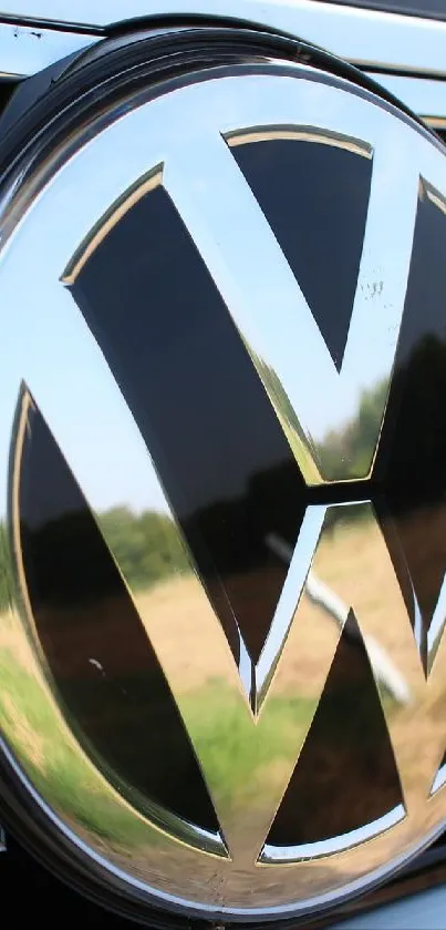Close-up of a Volkswagen car logo against a sleek black grille.
