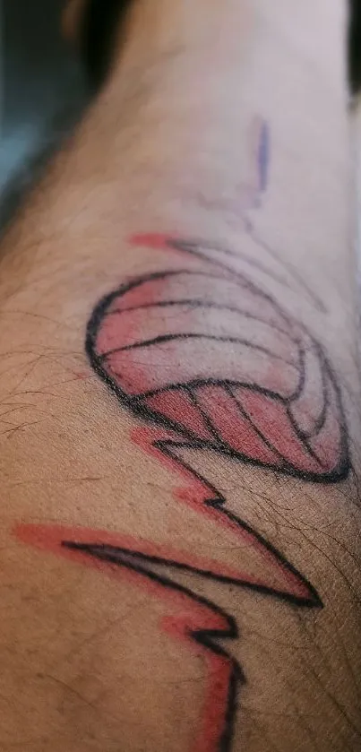 Volleyball tattoo on a forearm, artistic design.