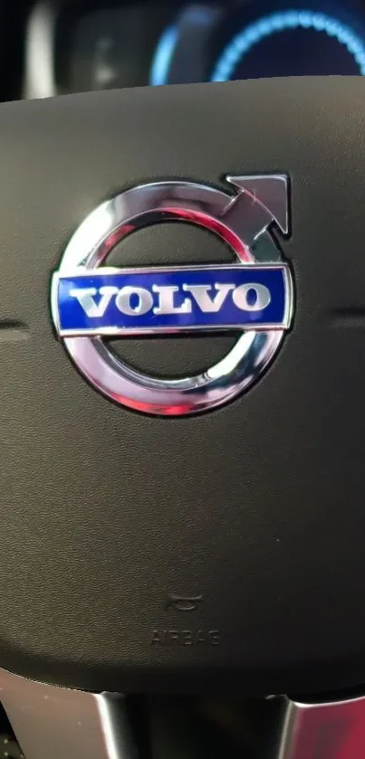 Close-up of Volvo steering wheel displaying the logo.