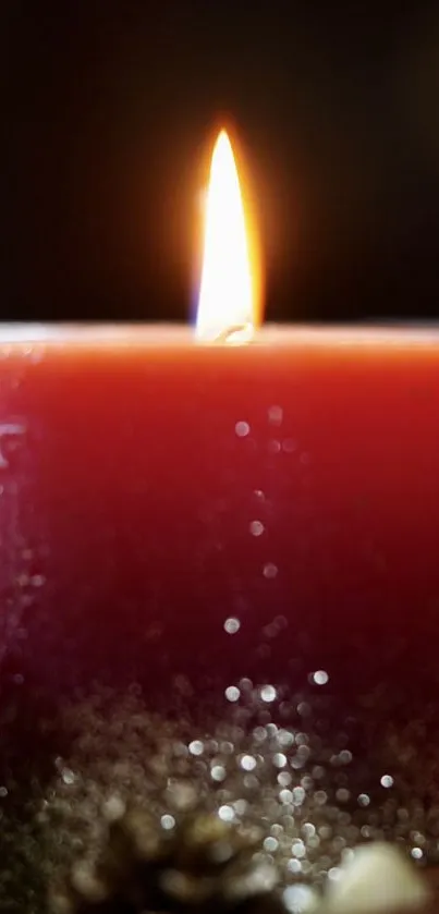 Rich red candle with glowing flame and warm ambiance.