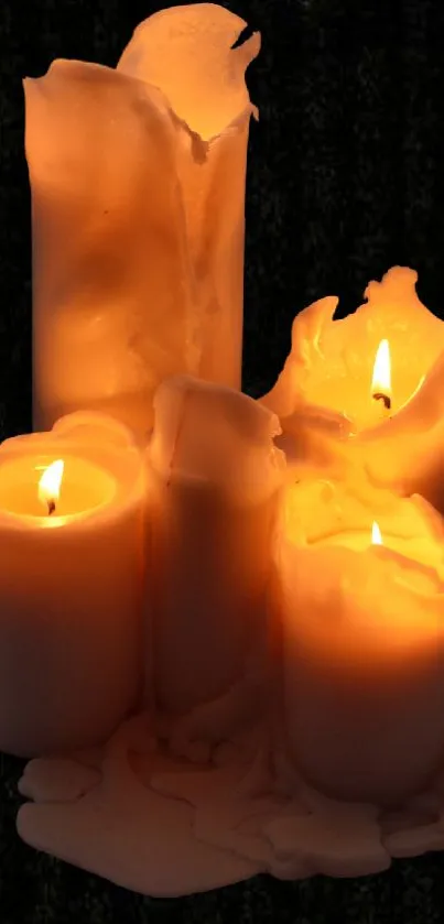 Flickering candles casting a warm glow in a dark setting.