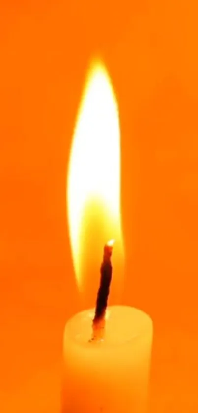 Candle flame against bright orange background.