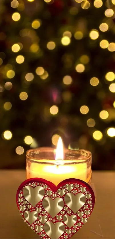 Candle with heart design in front of a festive bokeh background.