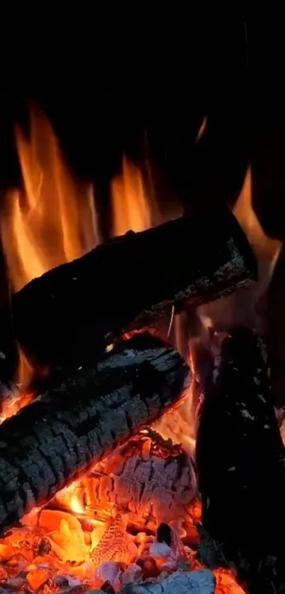 Mobile wallpaper of glowing orange flames and embers from a cozy fireplace.