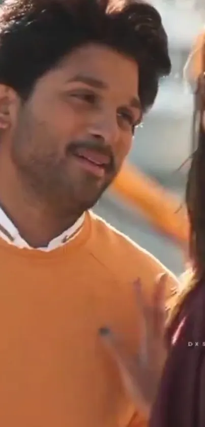 Smiling couple in bright orange attire.