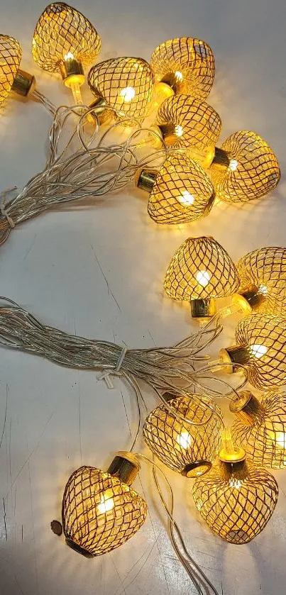 Golden string lights creating a warm glow on a white surface.