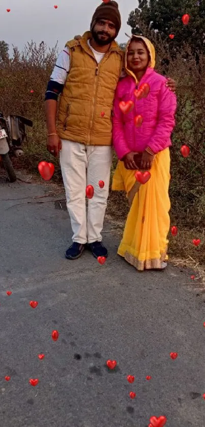 Couple standing on a rural road at sunset.