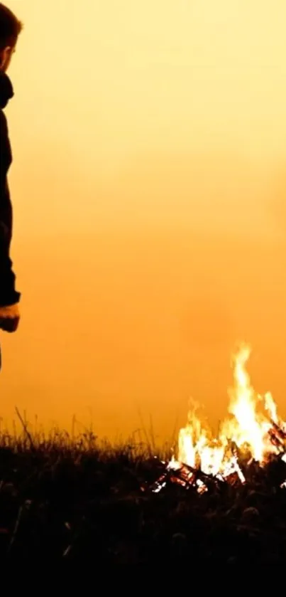 Silhouetted figure by campfire with orange sunset backdrop.