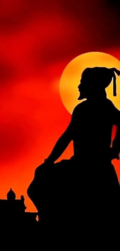 Silhouette of a warrior against a fiery sunset background.