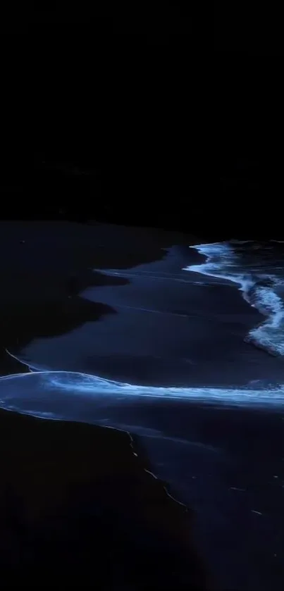 Bioluminescent ocean waves glow at night on a dark tranquil beach.