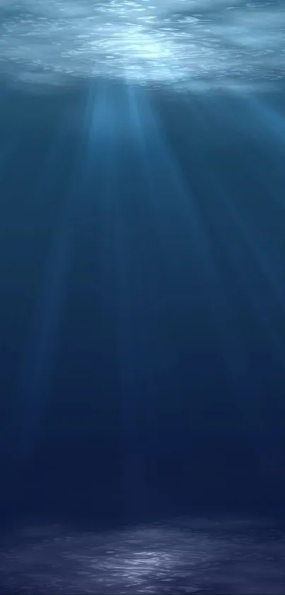 Serene underwater ocean with light rays penetrating the deep blue water.