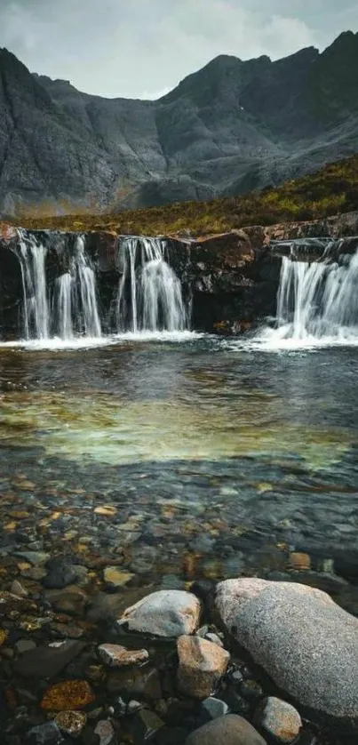 Serene waterfall and mountain landscape wallpaper.