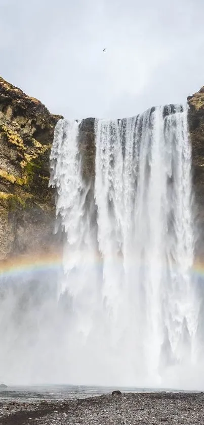 Stunning waterfall with vibrant rainbow in nature.