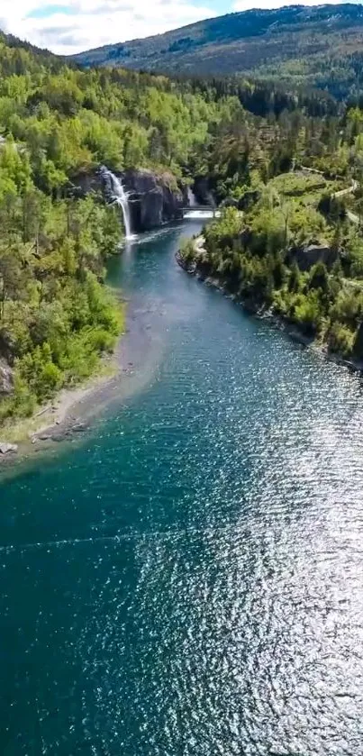 Aerial view of a river with a waterfall in a green forest landscape.