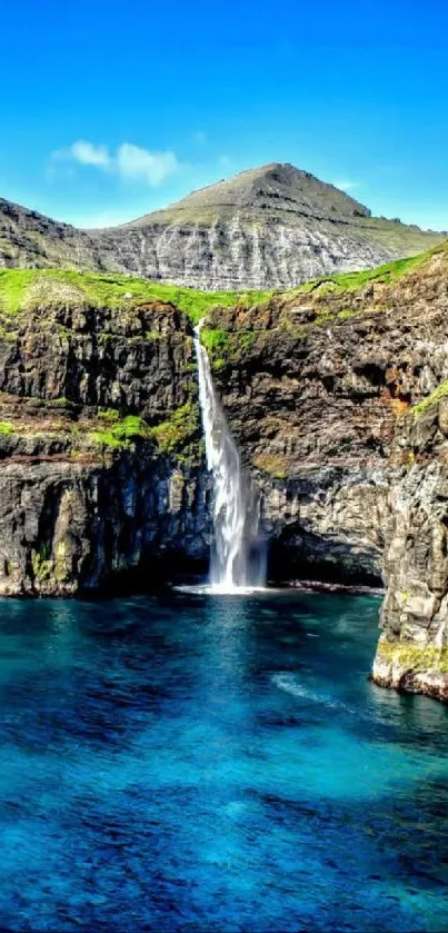 Scenic waterfall flowing over cliffs into blue waters under a bright sky.