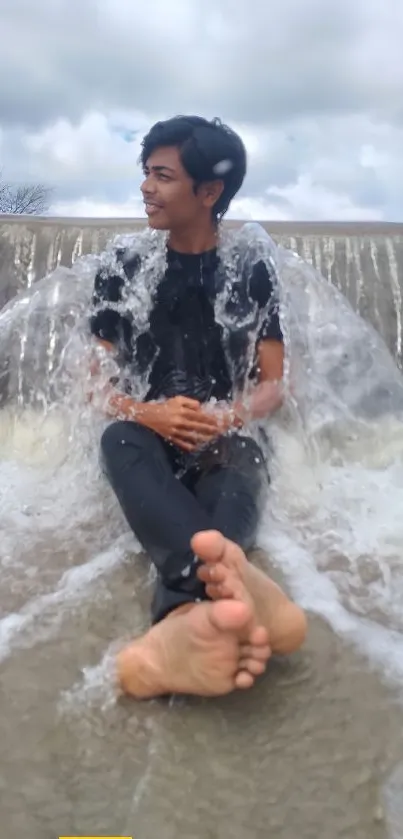 Person relaxing by a cascading waterfall.