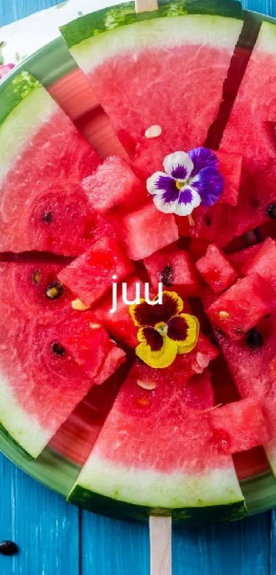 Watermelon slices arranged as popsicles on blue background with flowers.