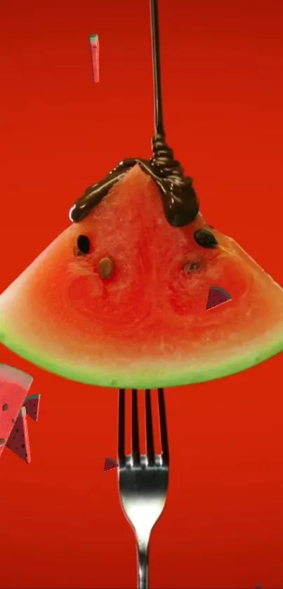 Watermelon slice on fork with chocolate drizzle on red background.