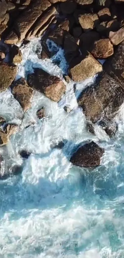 Aerial view of ocean waves crashing on rocky shoreline.